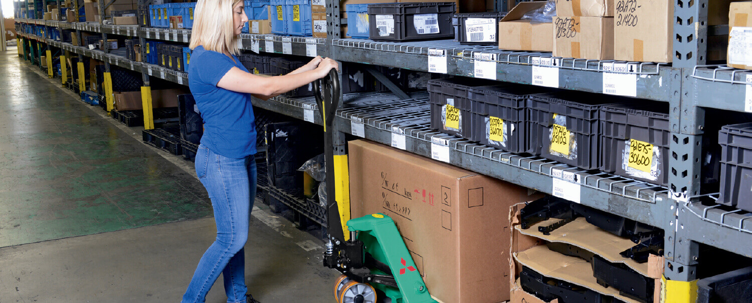 Woman loading Mitsubishi hand pallet truck with box